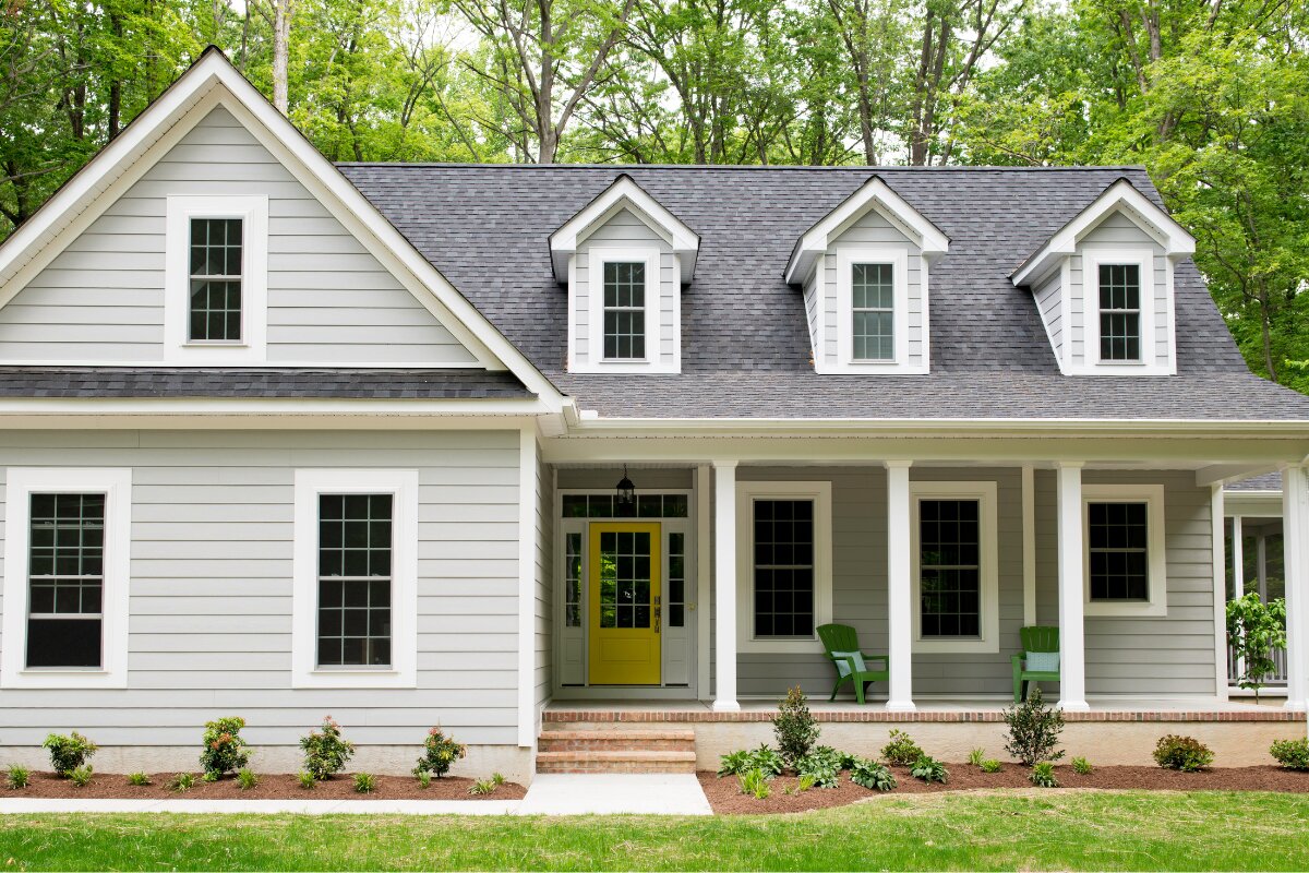 Cape cod home with white gutters — Foothills Gutter Pro install